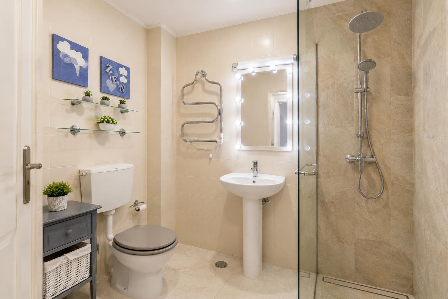 Bathroom — second view showing fixtures and bright tiling