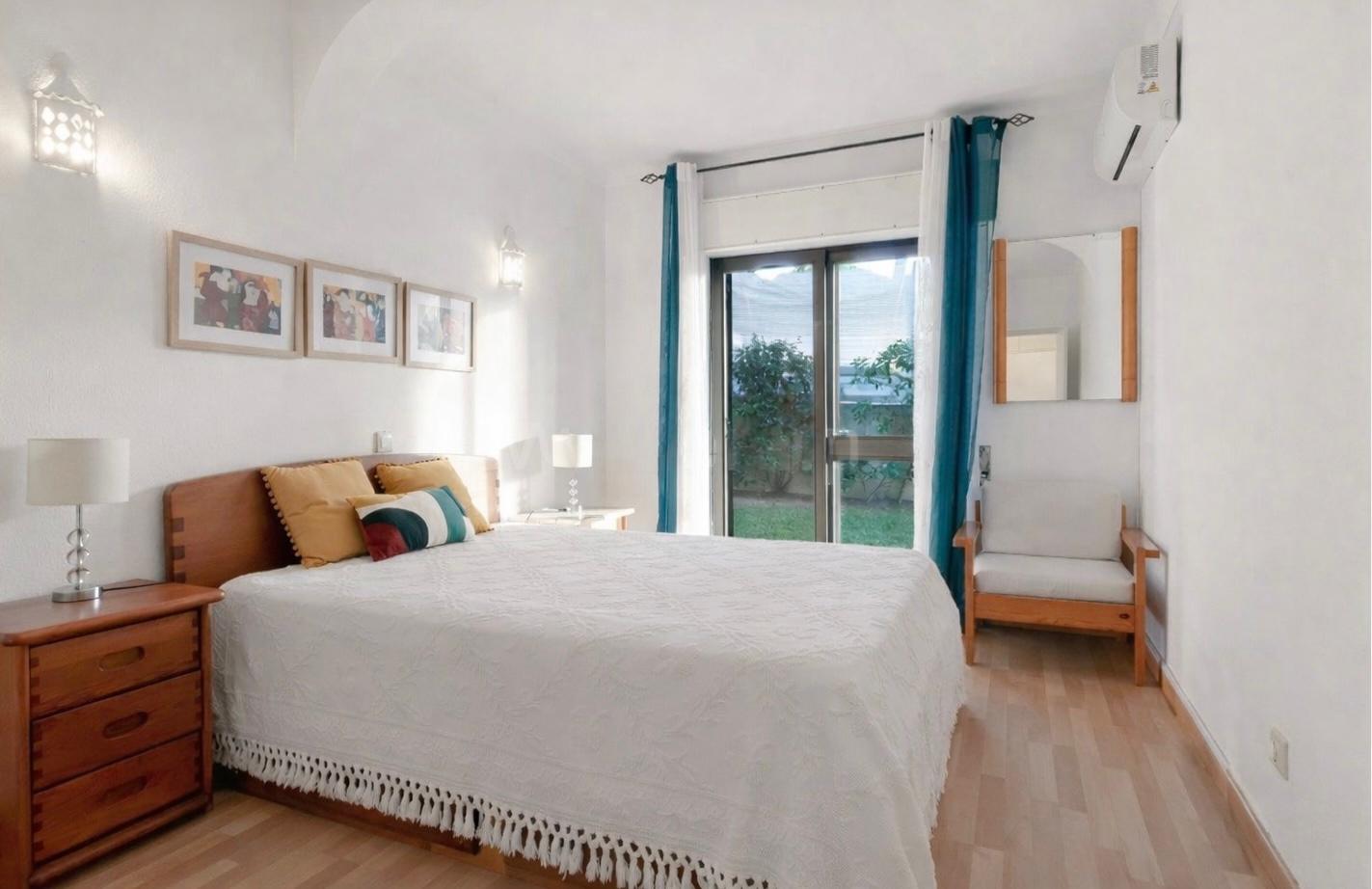 Main bedroom detail — soft furnishings and warm tones