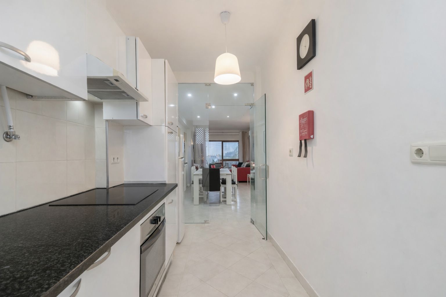 Kitchen storage and cooking surfaces seen from the entrance