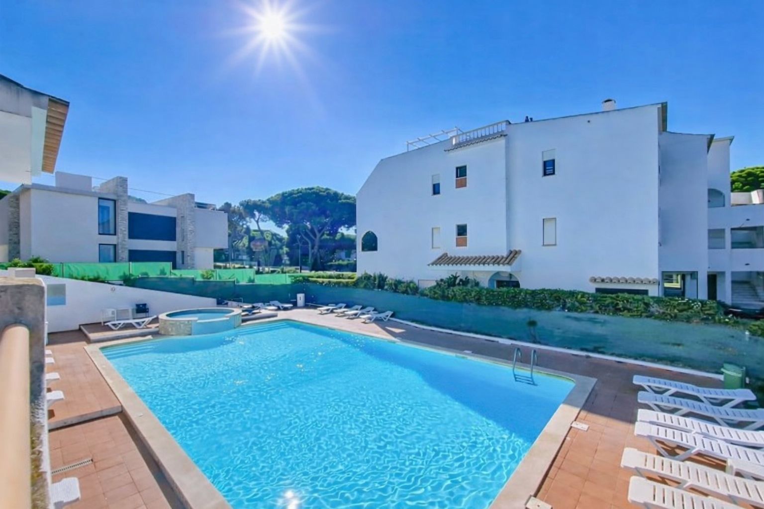Private pool on a tiled terrace, with sun loungers in the warm Algarve light
