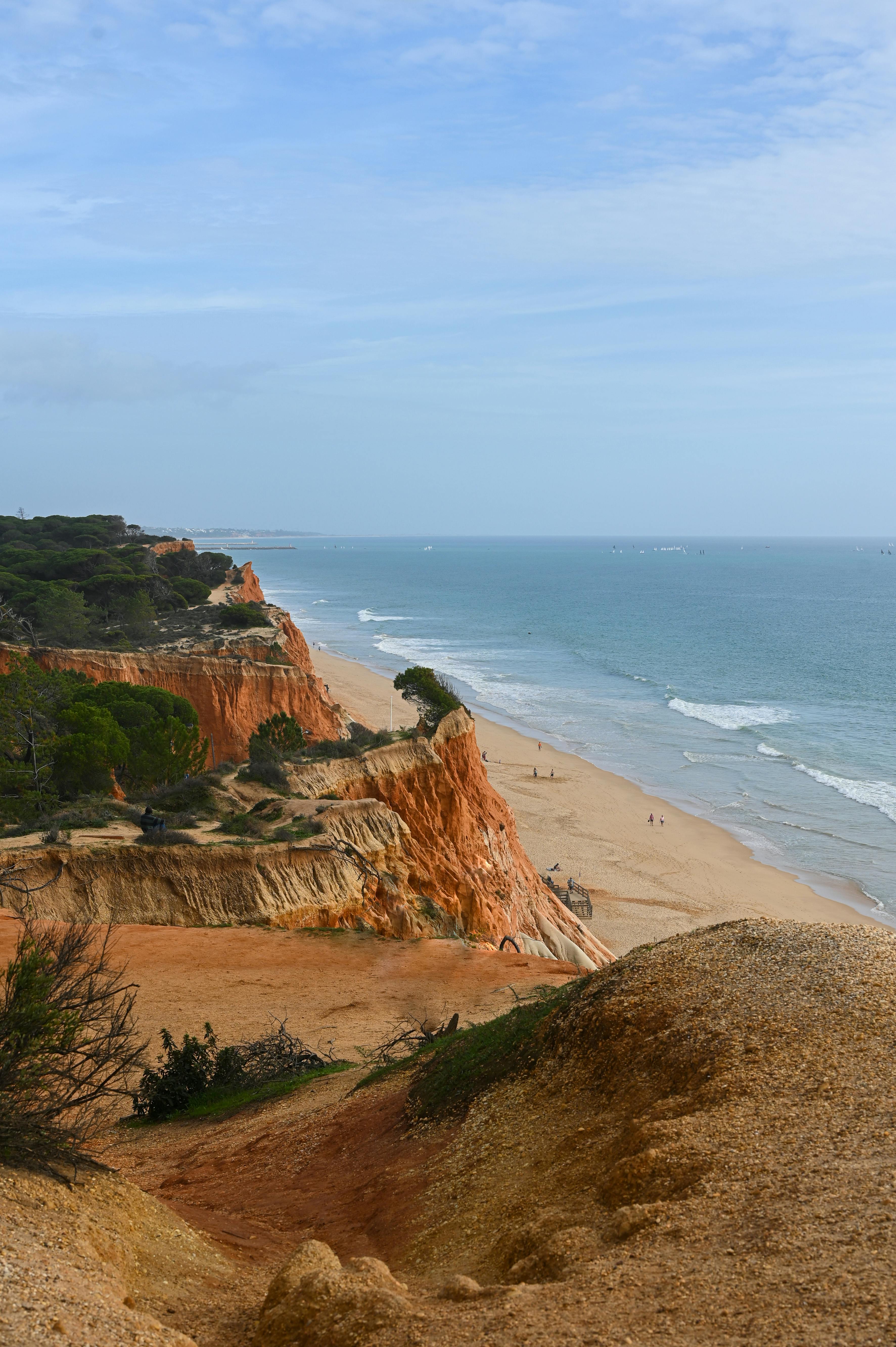 Red sandstone cliffs of Praia da Falésia above a long stretch of beach