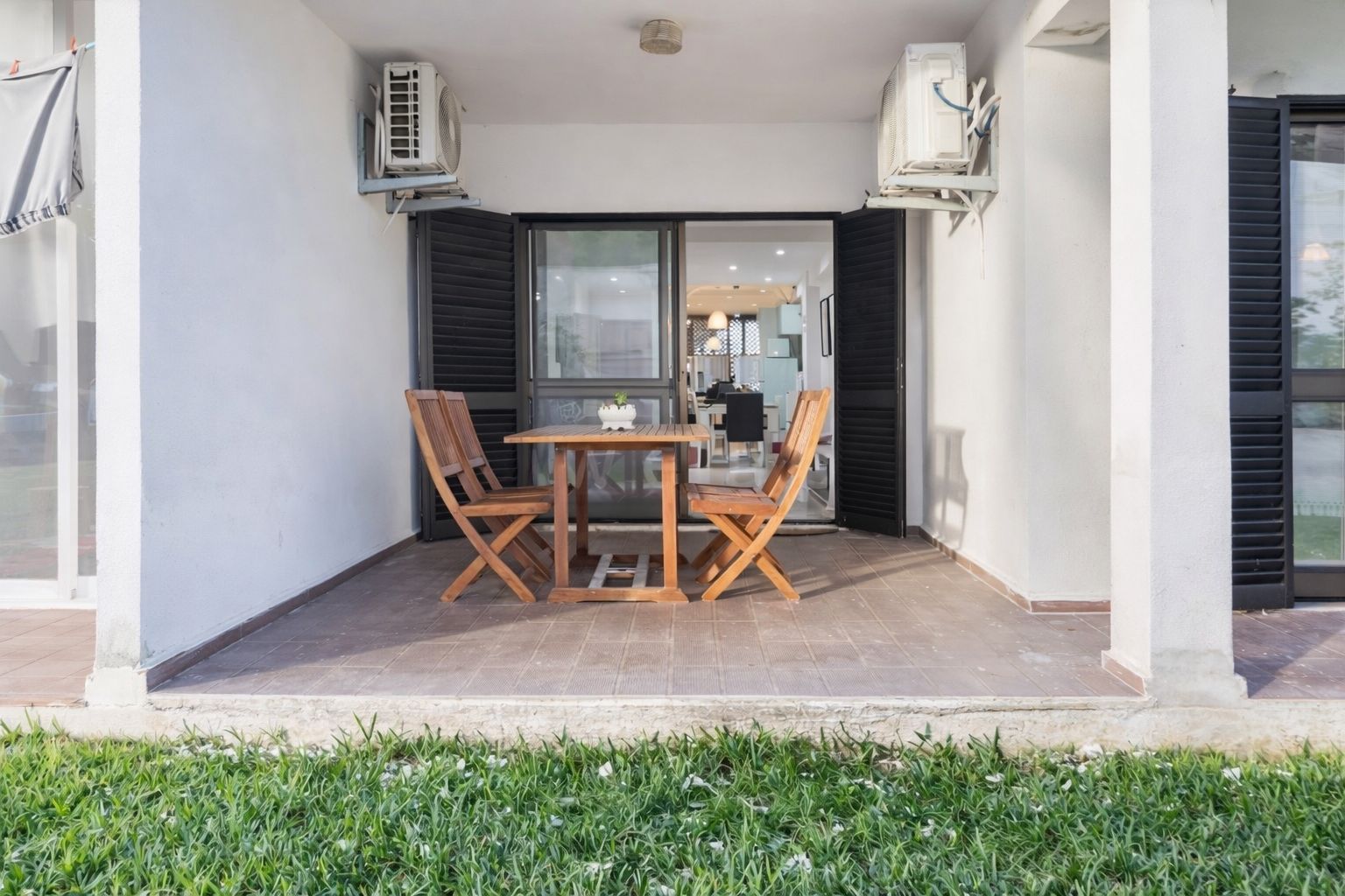 Shaded terrace with an outdoor dining table and soft morning light