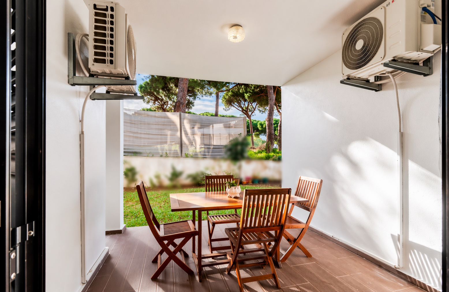 Terrace seen at a wider angle with the pool and garden beyond